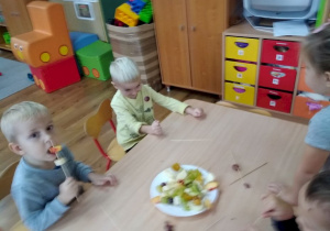 Dzieci robią szaszłyki owocowe